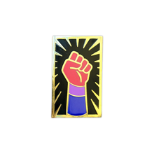 Load image into Gallery viewer, Enamel pin of a raised fist colored like the bisexual flag with gold outlining against a black background with a gold sunburst. 