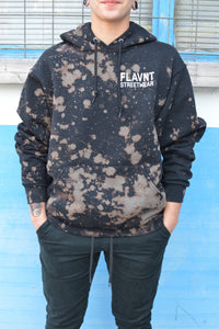A model is shown wearing the sweatshirt with black sweatpants in front of a blue wall from the front.